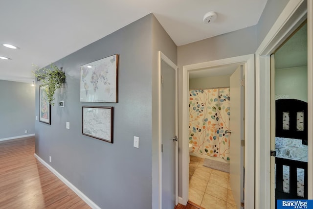 corridor featuring baseboards