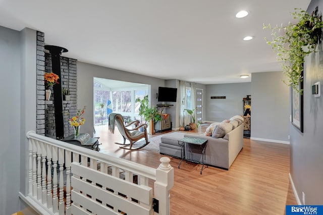 living area featuring recessed lighting, light wood-style flooring, and baseboards