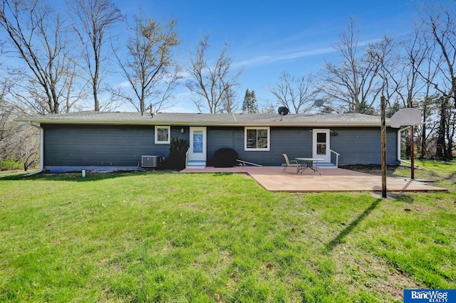 back of property with a patio area, a lawn, and central air condition unit