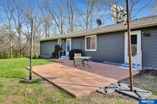 back of property with a yard, a patio, entry steps, and central AC
