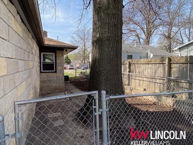 view of home's exterior featuring fence and a gate