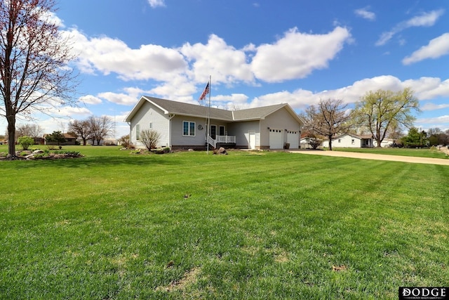 view of front of property with driveway, an attached garage, and a front lawn