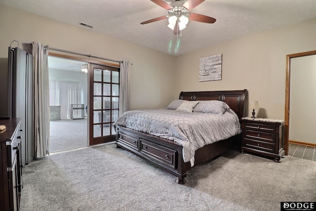 bedroom featuring access to exterior, carpet flooring, a ceiling fan, and visible vents