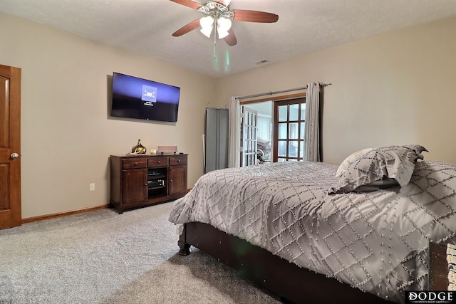 carpeted bedroom featuring visible vents, baseboards, and ceiling fan