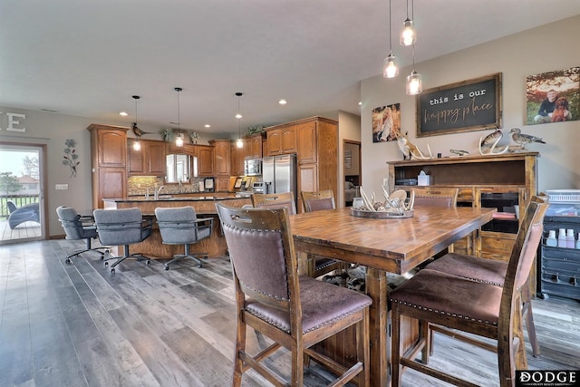 dining area featuring wood finished floors, recessed lighting, and a wealth of natural light