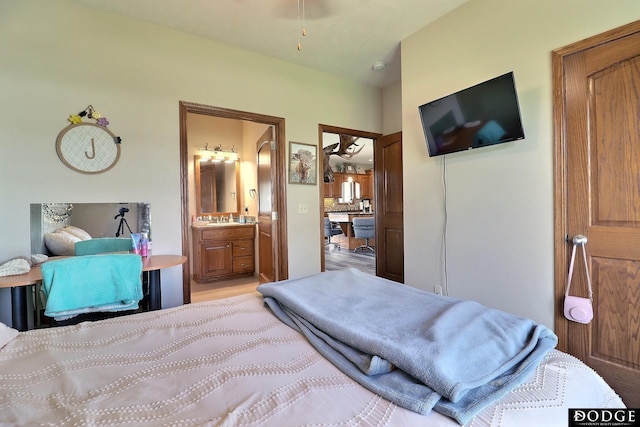 bedroom featuring a sink and connected bathroom