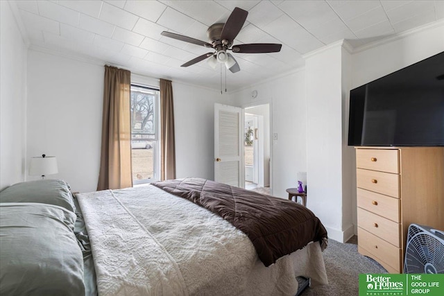carpeted bedroom featuring crown molding and a ceiling fan