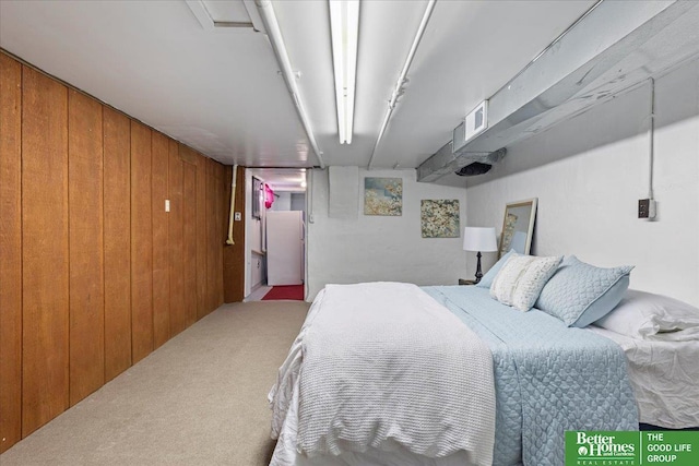 carpeted bedroom with wood walls