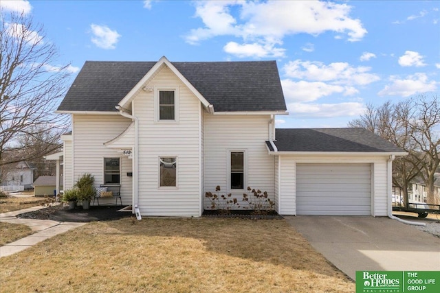 traditional home with a garage, a front yard, driveway, and a shingled roof