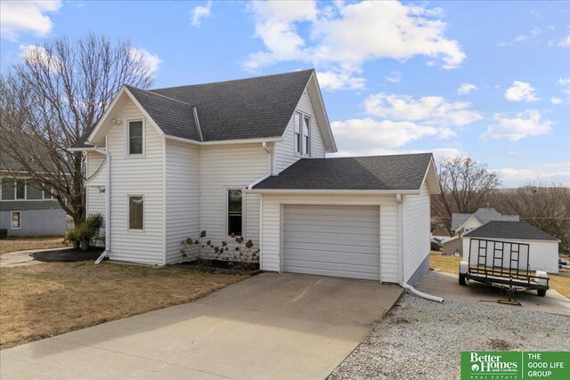 view of home's exterior featuring a shingled roof, driveway, and an attached garage
