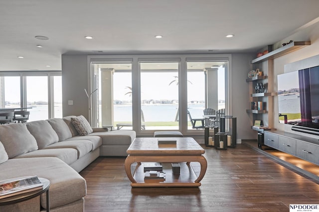 living area with recessed lighting, dark wood-style flooring, and a healthy amount of sunlight