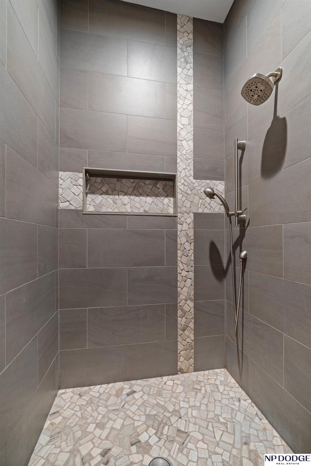 full bath with a tile shower