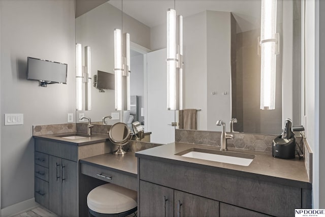 full bathroom featuring a sink and two vanities