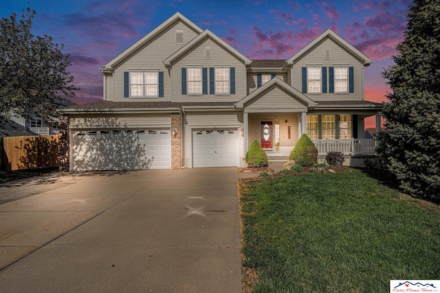 traditional-style house featuring a garage, fence, driveway, a porch, and a yard