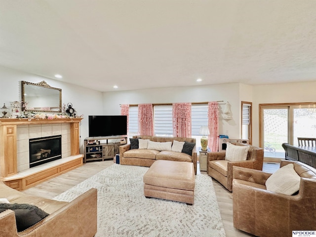 living room featuring light wood-type flooring, plenty of natural light, and recessed lighting