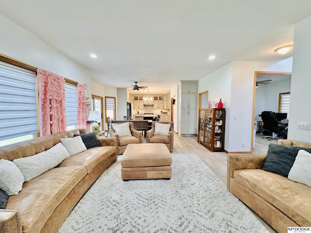 living area with ceiling fan, light wood-type flooring, recessed lighting, and baseboards