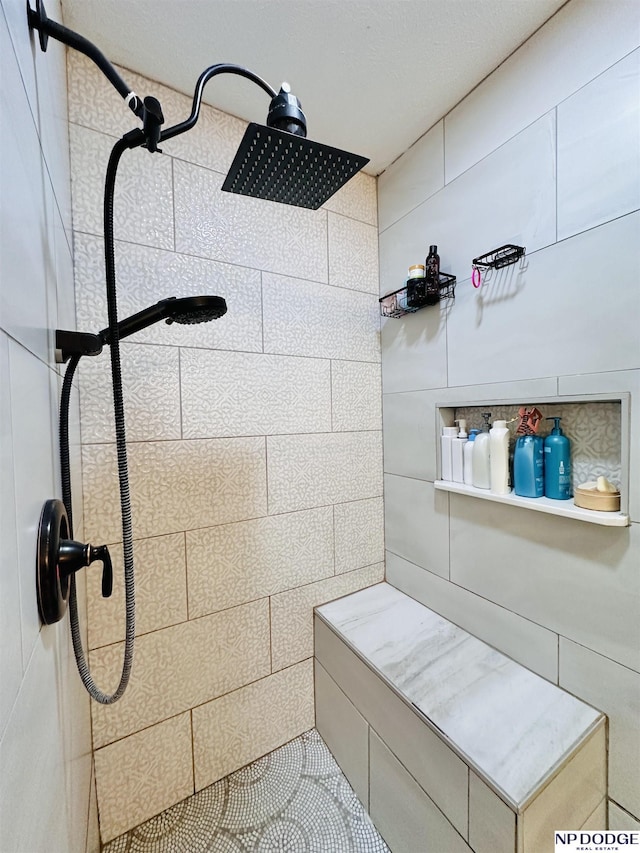 bathroom with tiled shower