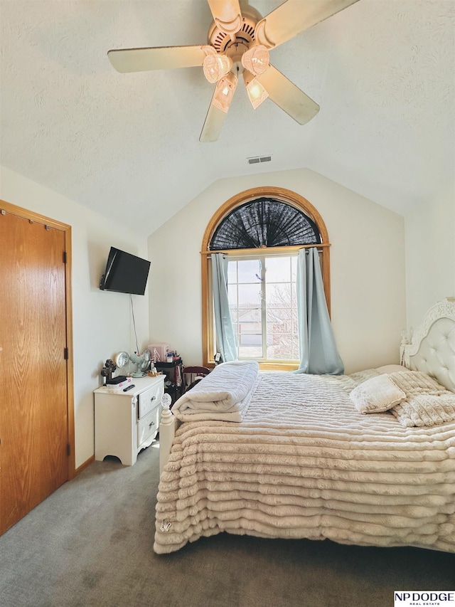 carpeted bedroom with visible vents, a ceiling fan, and lofted ceiling