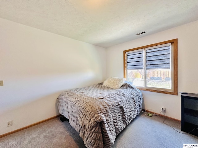 bedroom with visible vents, baseboards, and carpet flooring