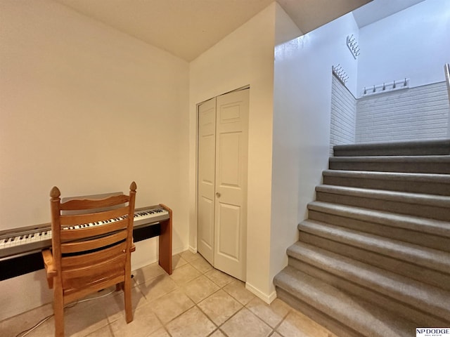 stairs with tile patterned floors and baseboards