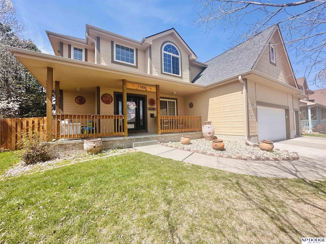 traditional-style home with a porch, a front yard, fence, a shingled roof, and driveway
