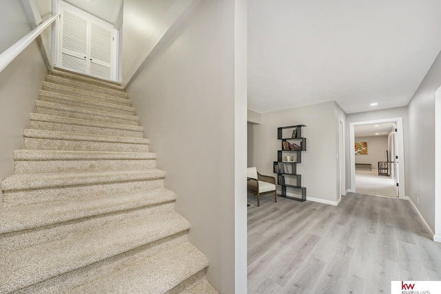 stairs featuring recessed lighting, baseboards, visible vents, and wood finished floors