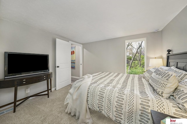 bedroom with baseboards and carpet