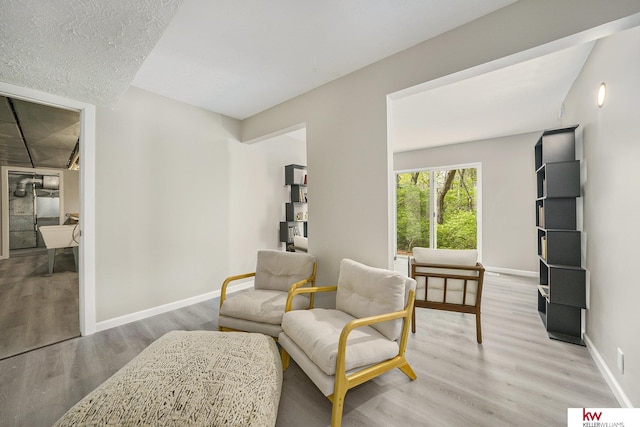 sitting room with light wood-style floors and baseboards