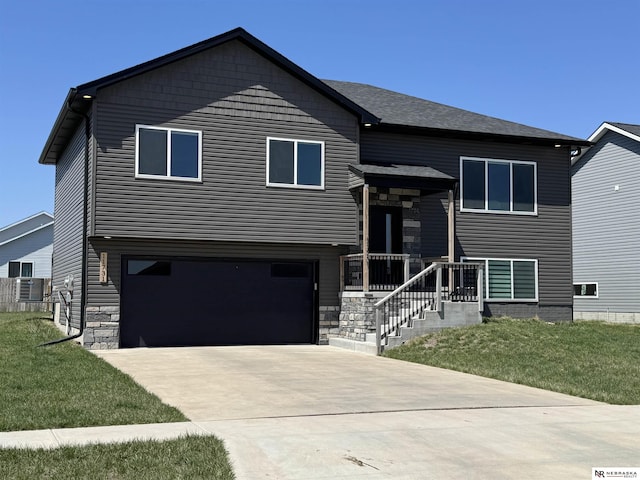 11731 N 144th St, Waverly, NE 68462 - view of front facade with an attached garage, driveway, a front lawn, and stone siding