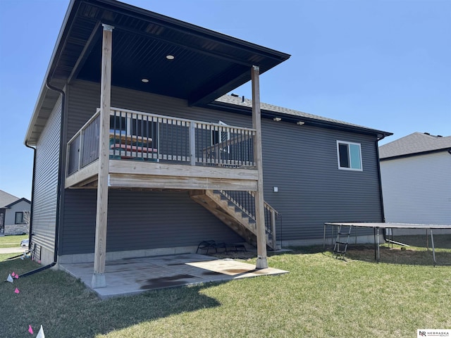 11731 N 144th St, Waverly, NE 68462 - rear view of house with a patio area, a trampoline, a yard, and a deck