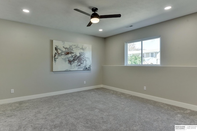 carpeted empty room with recessed lighting, a ceiling fan, and baseboards