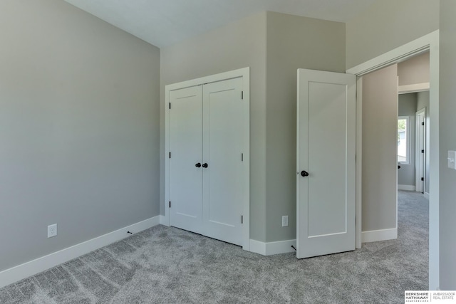 unfurnished bedroom with carpet floors and baseboards