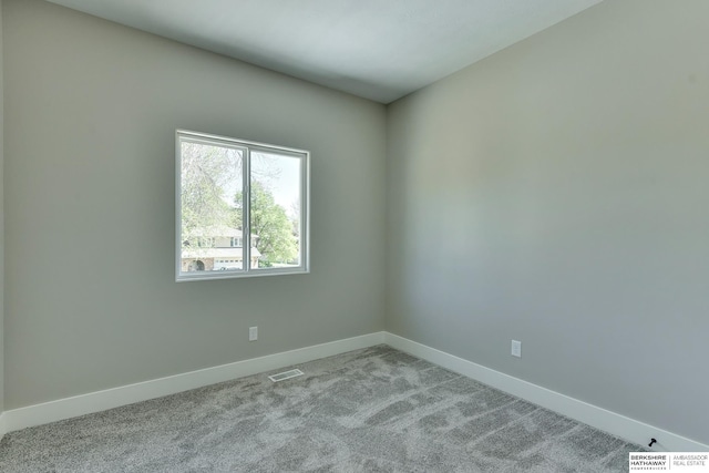 unfurnished room featuring baseboards, carpet, and visible vents