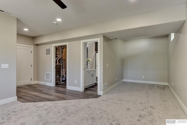 basement featuring carpet flooring and visible vents