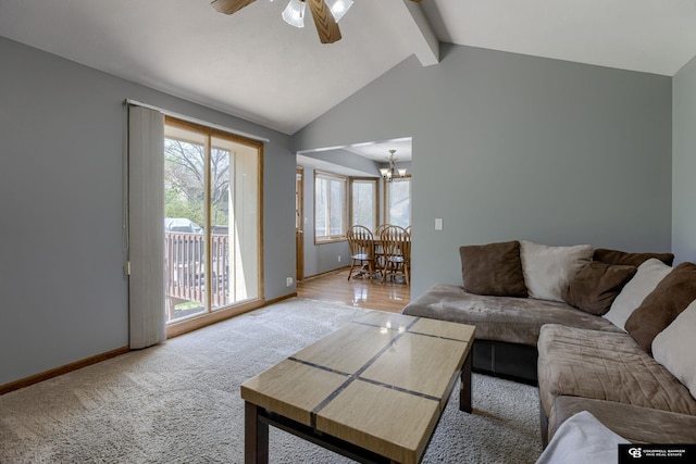 carpeted living area with baseboards, plenty of natural light, vaulted ceiling with beams, and ceiling fan with notable chandelier
