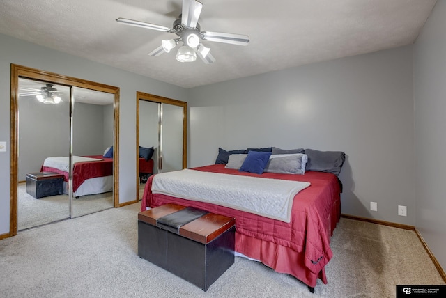 bedroom with baseboards, carpet flooring, multiple closets, and ceiling fan