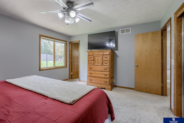 bedroom with visible vents, baseboards, carpet floors, and ceiling fan