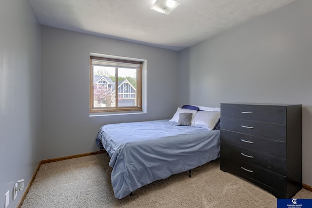 bedroom featuring carpet floors and baseboards