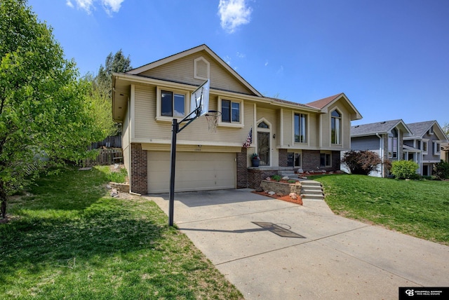 split foyer home featuring brick siding, an attached garage, a front yard, and concrete driveway