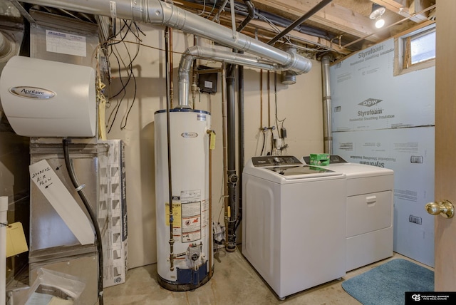 clothes washing area with separate washer and dryer, laundry area, and gas water heater