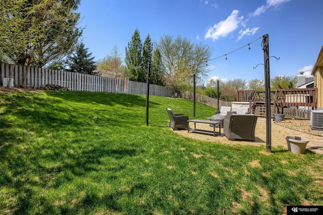view of yard featuring a fenced backyard, cooling unit, and a deck