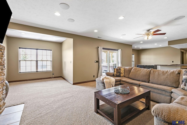 living room featuring light carpet, recessed lighting, a ceiling fan, and a healthy amount of sunlight