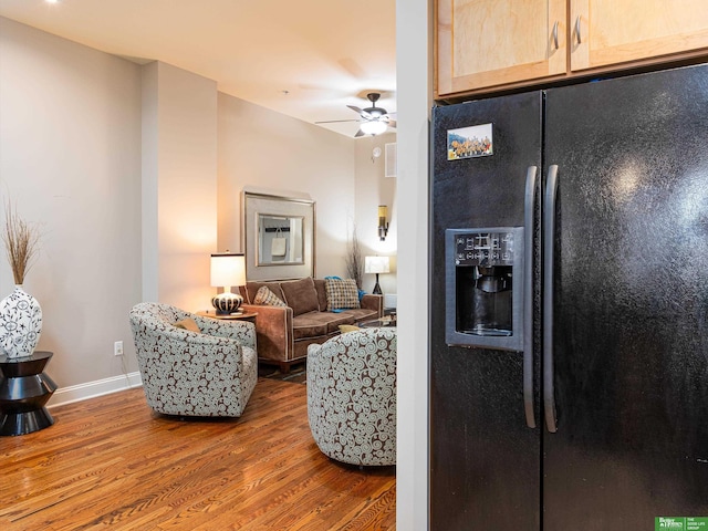 210 S 16th St Unit 901, Omaha, NE 68102 - living room with wood finished floors, a ceiling fan, and baseboards