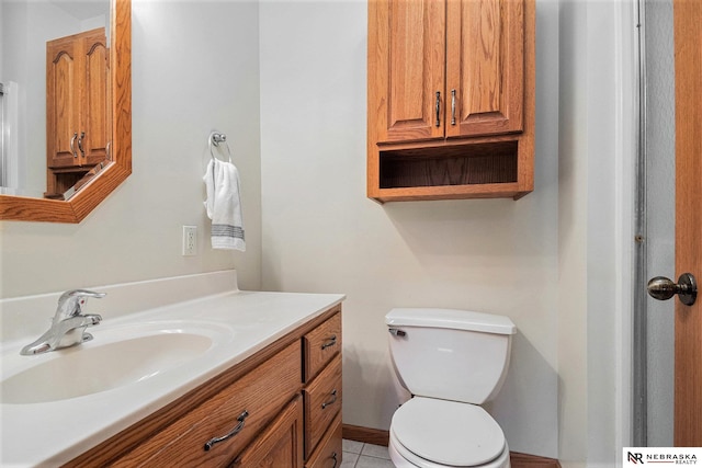 bathroom featuring toilet, vanity, and tile patterned flooring