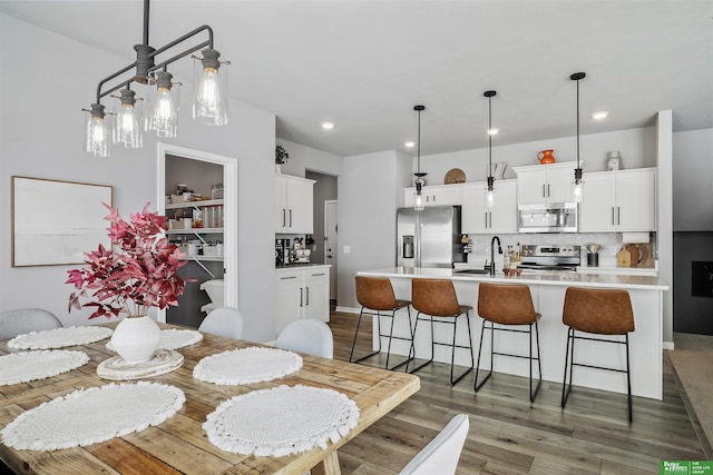 dining area with recessed lighting and wood finished floors