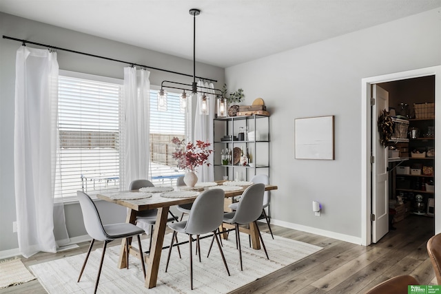 dining area with light wood finished floors, baseboards, and a wealth of natural light