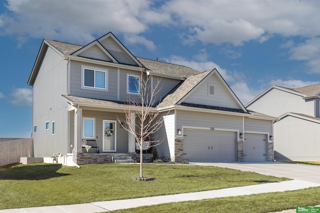 craftsman house featuring concrete driveway, stone siding, an attached garage, a front yard, and a shingled roof