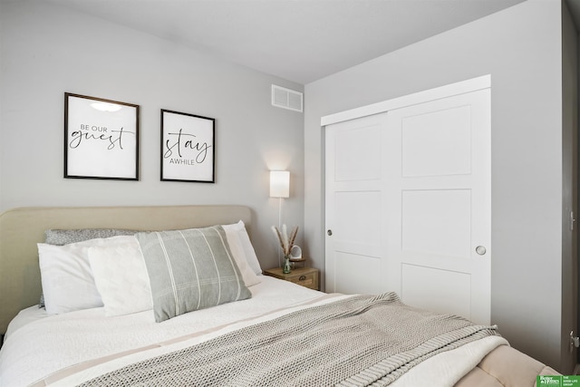 bedroom featuring visible vents and a closet