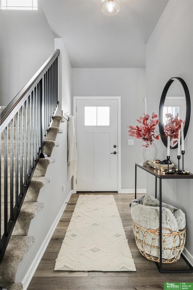 entrance foyer featuring baseboards and dark wood finished floors