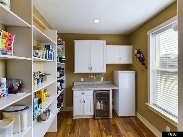 interior space featuring refrigerator, recessed lighting, wood finished floors, wine cooler, and baseboards